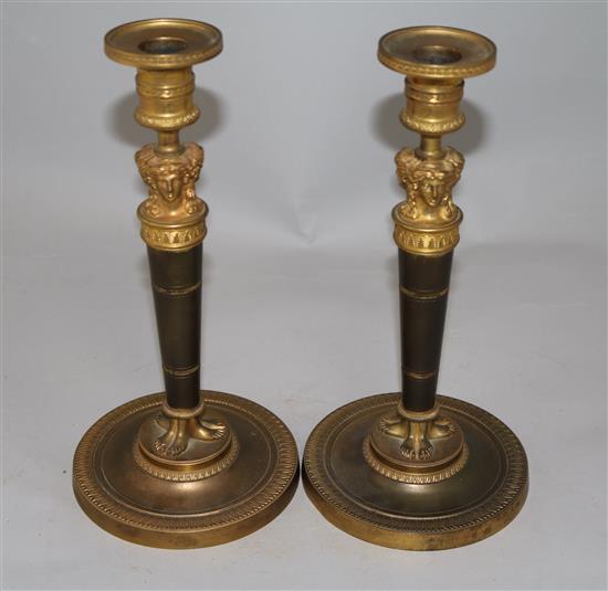 A pair of Empire style bronzed ormolu candlesticks, 10.5in.